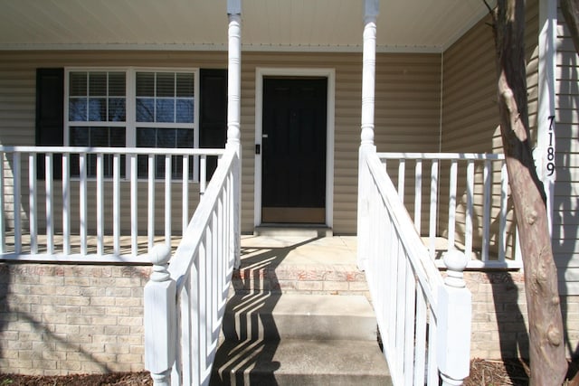 view of exterior entry with covered porch