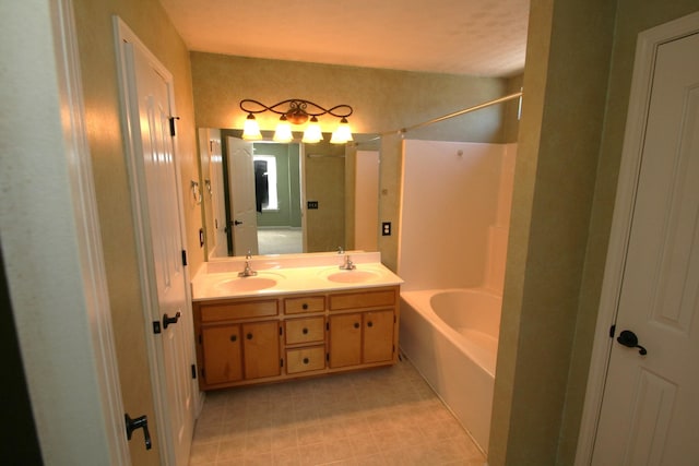 bathroom with a sink, shower / bathtub combination, and double vanity