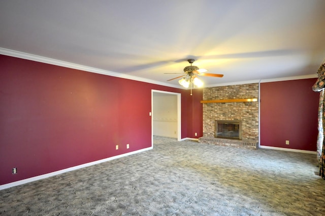 unfurnished living room with carpet, ornamental molding, a ceiling fan, a brick fireplace, and baseboards