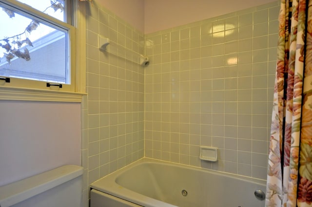 full bathroom featuring a combined bath / shower with jetted tub and toilet