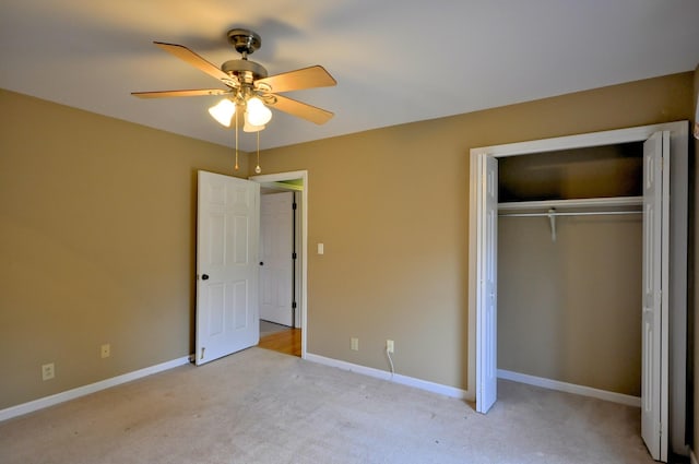 unfurnished bedroom with carpet, a closet, ceiling fan, and baseboards