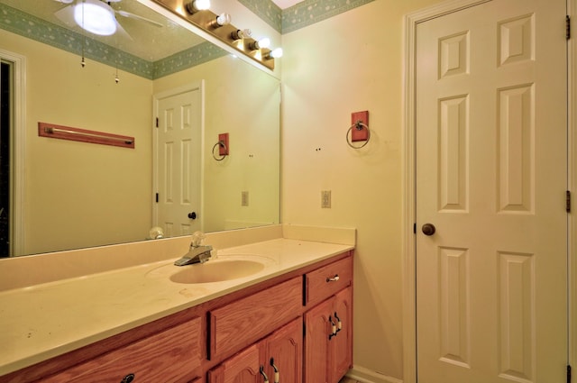 bathroom with a ceiling fan and vanity