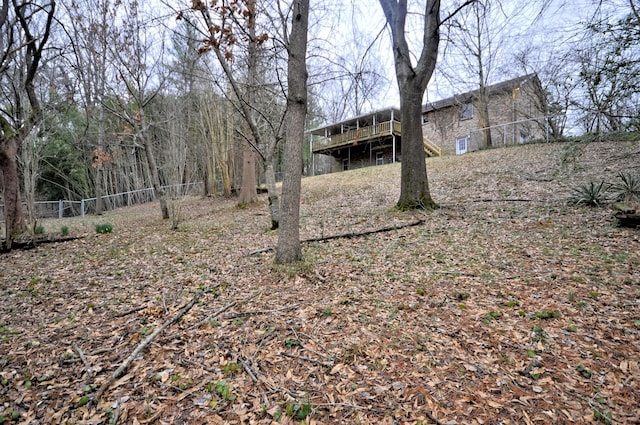 view of yard with a deck and fence