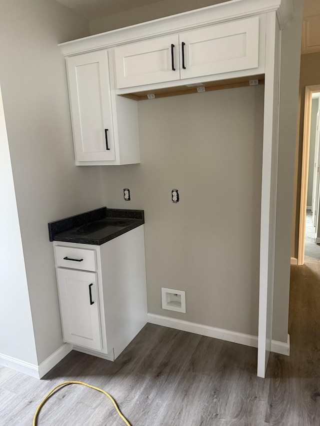 clothes washing area featuring visible vents, dark wood finished floors, and baseboards