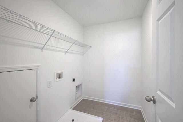 laundry area with laundry area, baseboards, visible vents, washer hookup, and electric dryer hookup