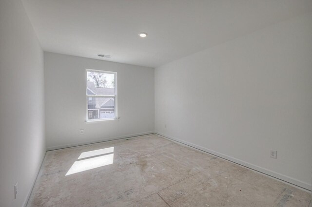 spare room with baseboards and visible vents