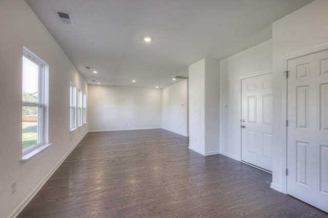 spare room with recessed lighting, dark wood finished floors, visible vents, and baseboards