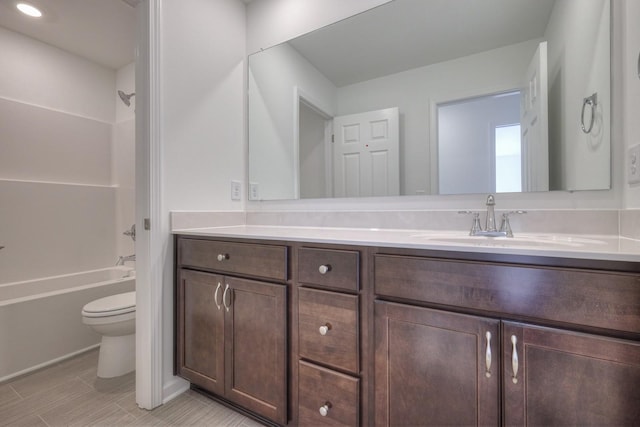 bathroom with  shower combination, vanity, and toilet