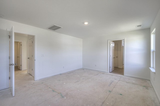 spare room with baseboards and visible vents