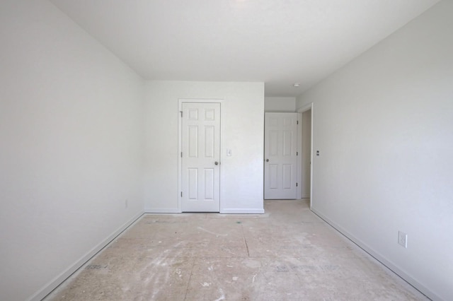 spare room with baseboards