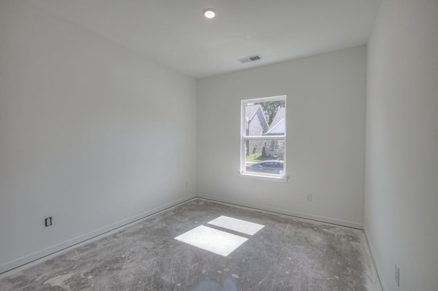 unfurnished room with visible vents and baseboards