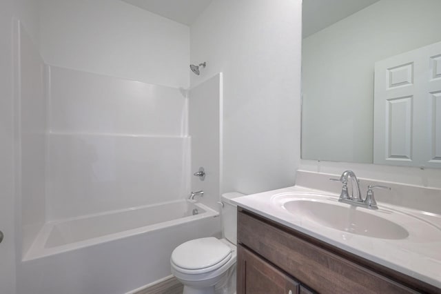 bathroom featuring tub / shower combination, vanity, and toilet