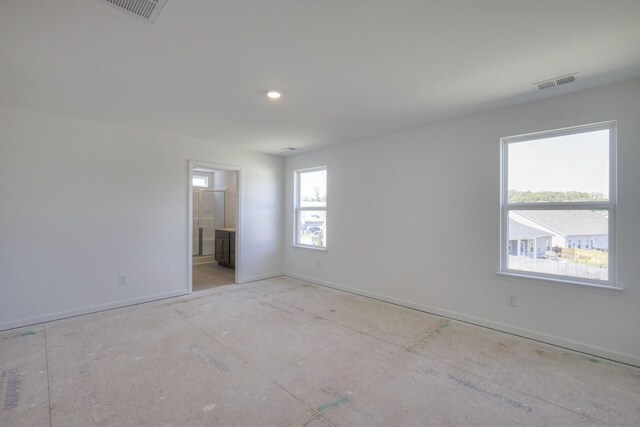 unfurnished room featuring visible vents and baseboards