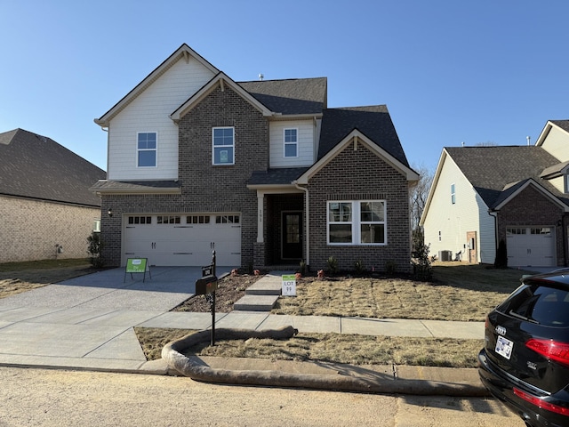 view of front facade with concrete driveway, brick siding, an attached garage, and cooling unit