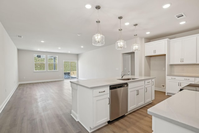 kitchen with light countertops, visible vents, dishwasher, and a sink