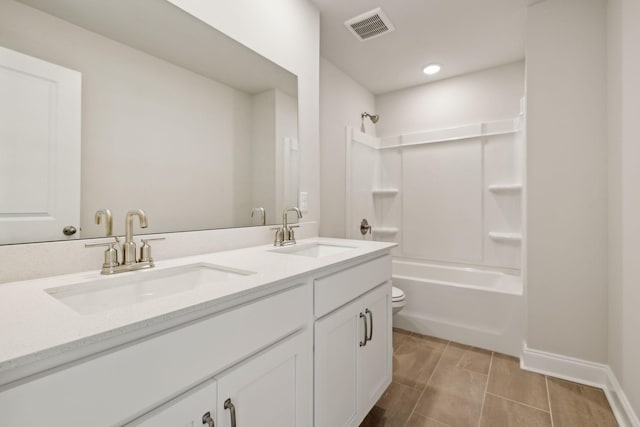 bathroom featuring double vanity, shower / bath combination, visible vents, and a sink