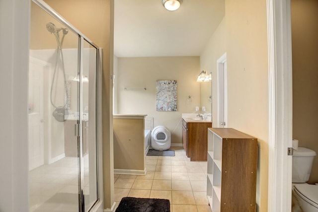 full bath with a stall shower, tile patterned flooring, vanity, and toilet