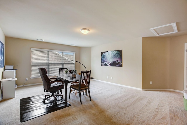 carpeted dining area with attic access, visible vents, and baseboards