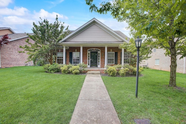 view of front of house featuring covered porch, brick siding, and a front lawn