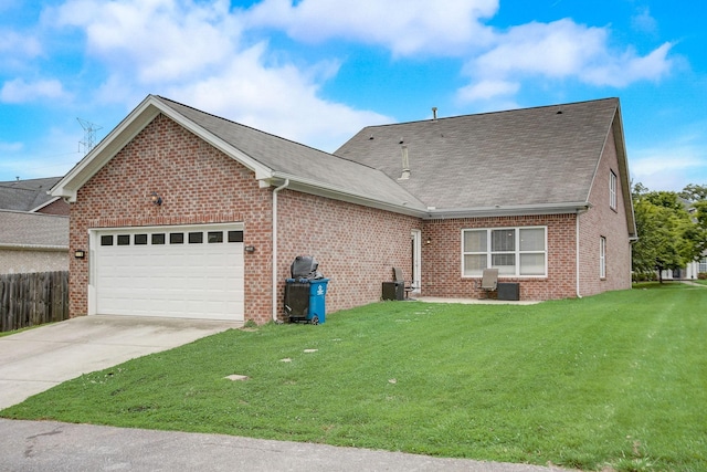 exterior space with a garage, concrete driveway, brick siding, and a lawn