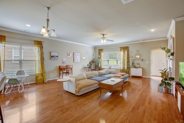 living area featuring a ceiling fan, visible vents, baseboards, light wood-type flooring, and crown molding