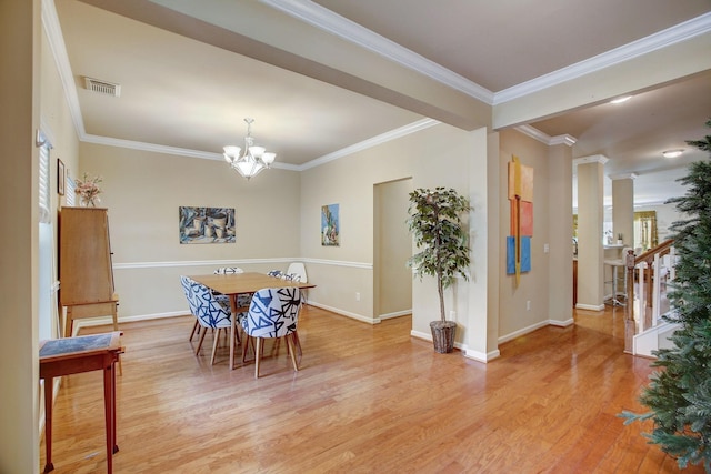 dining room featuring a notable chandelier, visible vents, baseboards, ornamental molding, and light wood-type flooring