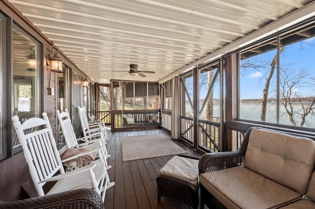 sunroom / solarium featuring a water view, wooden ceiling, and a ceiling fan