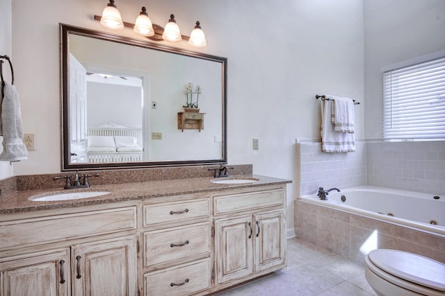 ensuite bathroom with double vanity, ensuite bath, tile patterned floors, a jetted tub, and a sink