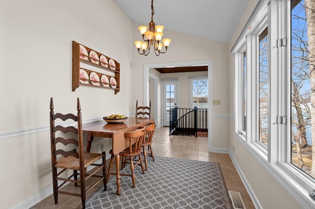 dining room with vaulted ceiling, a chandelier, visible vents, and baseboards