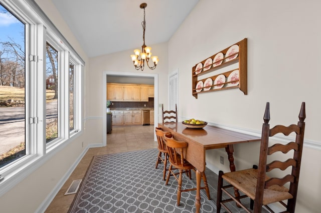 dining space with light tile patterned floors, visible vents, vaulted ceiling, a chandelier, and baseboards