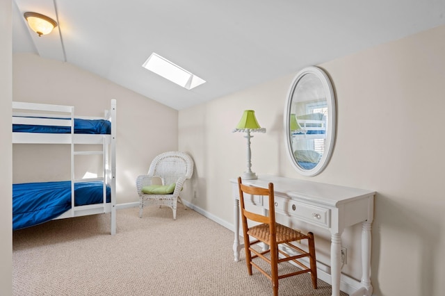 carpeted bedroom featuring lofted ceiling with skylight and baseboards