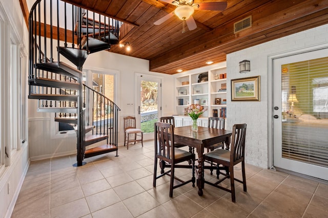 tiled dining area featuring built in shelves, visible vents, wood ceiling, brick wall, and stairs