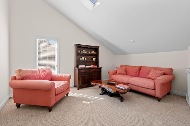 living area featuring lofted ceiling with skylight, baseboards, and light colored carpet