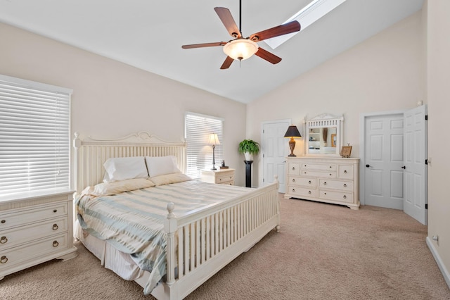 bedroom featuring vaulted ceiling, ceiling fan, and light colored carpet