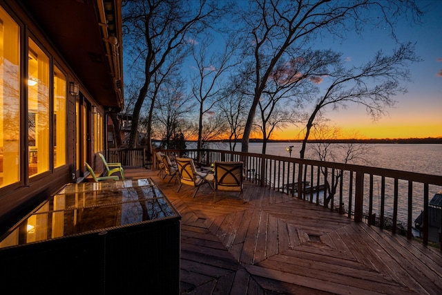 wooden terrace featuring a water view