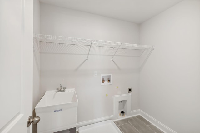 laundry area featuring gas dryer hookup, hookup for an electric dryer, laundry area, washer hookup, and baseboards