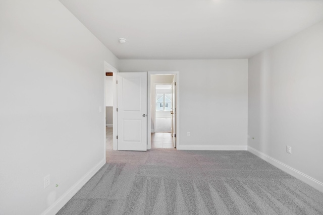 spare room with carpet flooring and baseboards