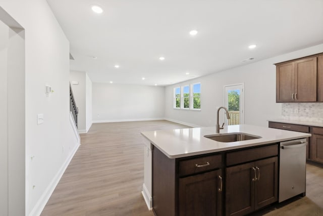 kitchen featuring light wood-style flooring, recessed lighting, a sink, light countertops, and dishwasher