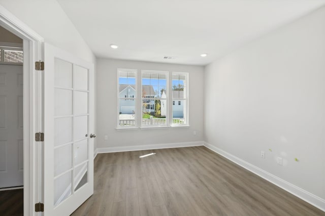 spare room featuring visible vents, baseboards, wood finished floors, and recessed lighting