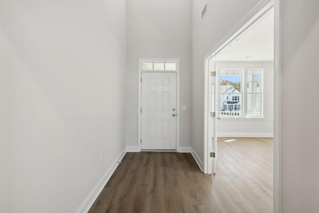 entryway featuring wood finished floors, visible vents, and baseboards