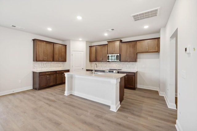 kitchen with stainless steel appliances, a sink, and visible vents