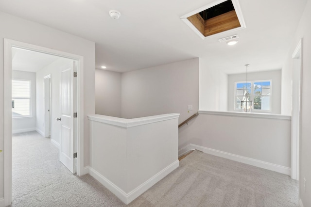 hall featuring carpet floors, recessed lighting, visible vents, an upstairs landing, and baseboards