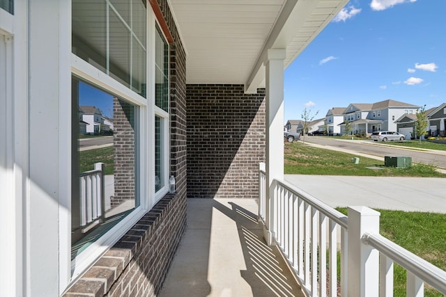 balcony with covered porch and a residential view