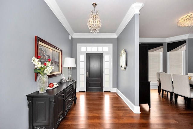 foyer entrance featuring crown molding, dark wood-style flooring, baseboards, and a notable chandelier