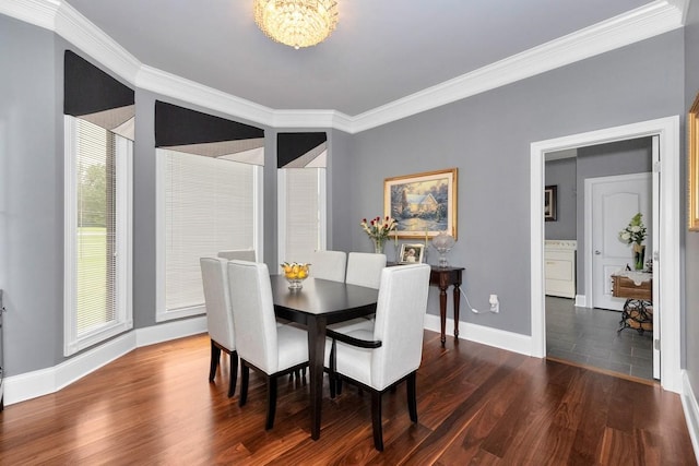 dining room with an inviting chandelier, crown molding, baseboards, and wood finished floors