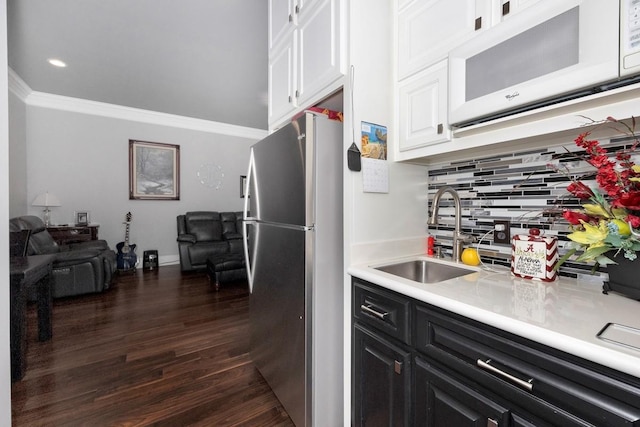18543 Tillman Mill Rd, Athens, AL 35614 - kitchen featuring white cabinets, white microwave, freestanding refrigerator, light countertops, and a sink
