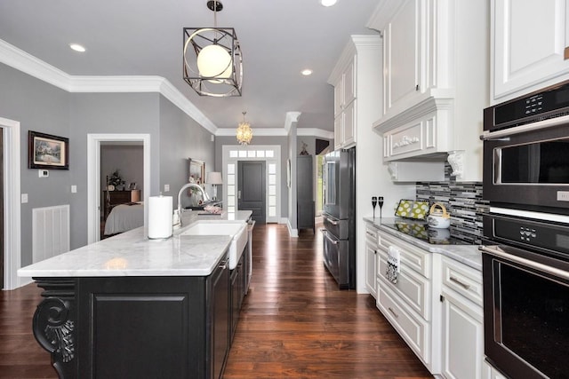 18543 Tillman Mill Rd, Athens, AL 35614 - kitchen featuring a center island with sink, visible vents, white cabinets, dark wood-style flooring, and black appliances