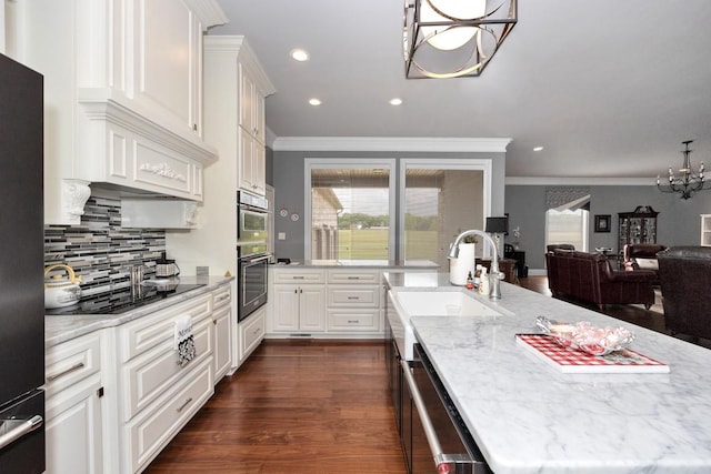 18543 Tillman Mill Rd, Athens, AL 35614 - kitchen featuring dark wood finished floors, a notable chandelier, backsplash, light stone countertops, and black appliances