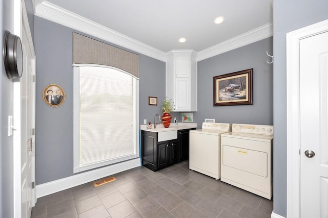 18543 Tillman Mill Rd, Athens, AL 35614 - washroom with a sink, visible vents, washer and dryer, cabinet space, and crown molding