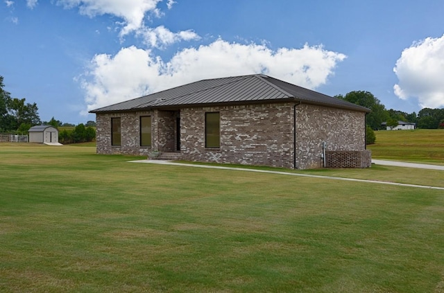 18543 Tillman Mill Rd, Athens, AL 35614 - view of front facade featuring a front yard, brick siding, metal roof, and an outbuilding